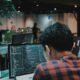 Game developer coding on a computer in a workspace