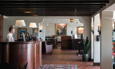 Hospitality professional working at a restaurant front desk in the UK