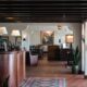 Hospitality professional working at a restaurant front desk in the UK