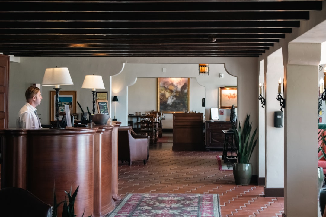 Hospitality professional working at a restaurant front desk in the UK