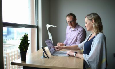 IT support professionals working together on a laptop in an office