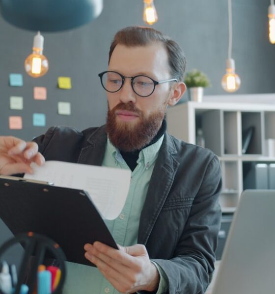 Job seeker reviewing documents and a job description at a desk