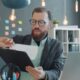 Job seeker reviewing documents and a job description at a desk