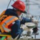 Telecommunications engineer working with network equipment and cables